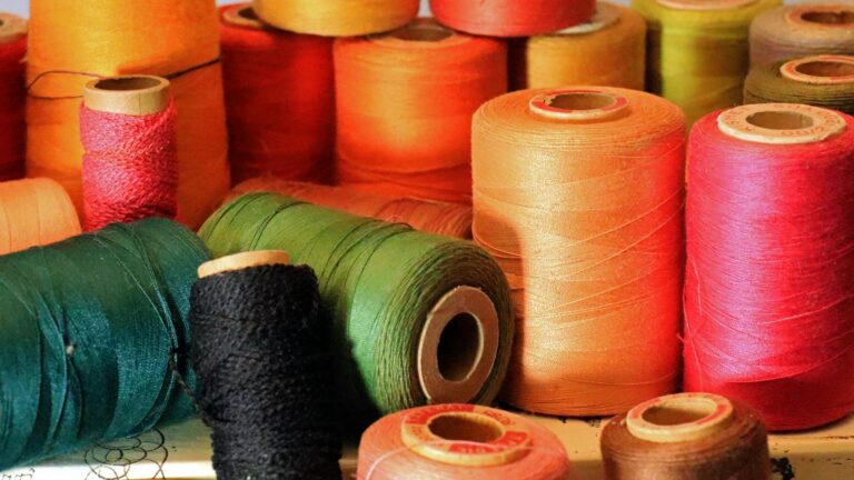 Vibrant and multicolored spools of thread create a lively visual in this close-up shot.