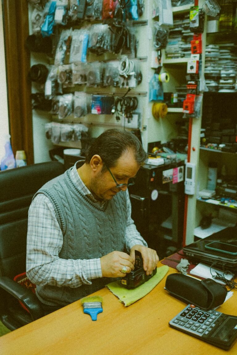 A shoemaker intently crafts in a cozy Istanbul workshop surrounded by tools and materials.