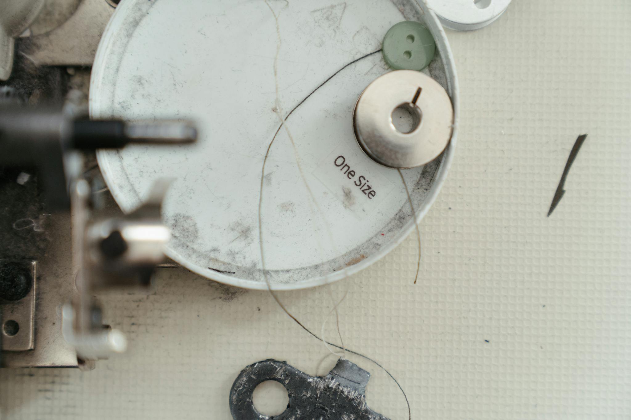 Detailed view of sewing machine parts and accessories showcasing needlework tools.